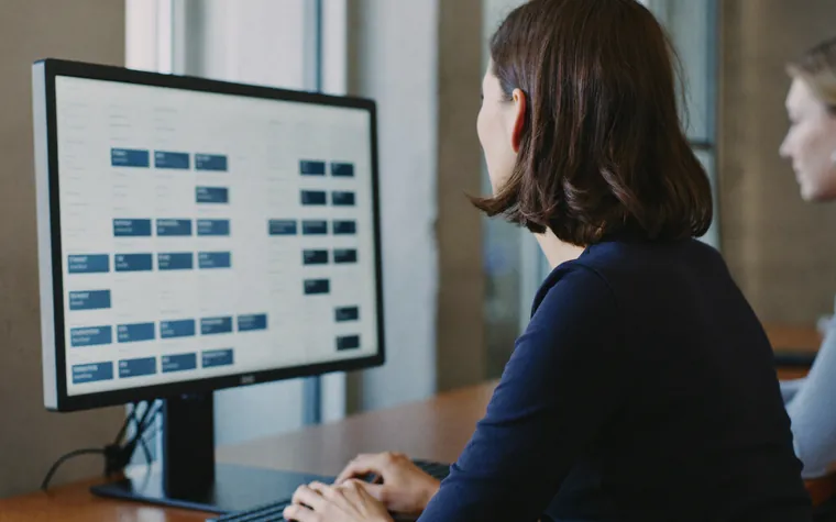 An administrator at a monitor working through a board of user accounts and the access set against each one